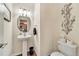 Stylish half bathroom featuring pedestal sink, modern fixtures, and decorative accents at 726 Vista Verde Hts, Monument, CO 80132