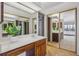 Bathroom featuring dual vanities, ample counter space, and a large mirrored closet at 13631 E Marina Dr # 201, Aurora, CO 80014