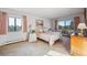 Bright bedroom with natural light, a large bed, and neutral decor at 13631 E Marina Dr # 201, Aurora, CO 80014