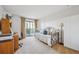 Comfortable bedroom with a daybed, desk area, and access to a private balcony at 13631 E Marina Dr # 201, Aurora, CO 80014