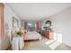Bright bedroom featuring a large window with pleasant views and a vintage wood dresser at 13631 E Marina Dr # 201, Aurora, CO 80014