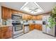 Bright kitchen with stainless steel appliances, wood cabinets, and plenty of counter space at 13631 E Marina Dr # 201, Aurora, CO 80014