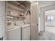 Convenient laundry room featuring a washer, dryer, and plenty of storage space at 13631 E Marina Dr # 201, Aurora, CO 80014