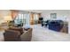 Inviting living room featuring plush seating, neutral carpeting, and sliding glass doors to a balcony at 13631 E Marina Dr # 201, Aurora, CO 80014
