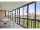 Relaxing sunroom with wall-to-wall windows offering a picturesque outdoor view with wicker furniture at 13631 E Marina Dr # 201, Aurora, CO 80014