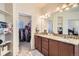 Bathroom with double vanity, granite countertops, and a walk-in closet at 10057 Granby St, Commerce City, CO 80022