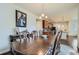 Elegant dining area adjoining the kitchen, featuring a stylish chandelier and hardwood floors at 10057 Granby St, Commerce City, CO 80022