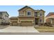 Inviting two-story home featuring a three car garage and a meticulously maintained lawn at 10057 Granby St, Commerce City, CO 80022