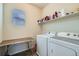 Functional laundry room featuring a folding table and a full-size washer and dryer at 10057 Granby St, Commerce City, CO 80022