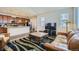Open-concept living room with hardwood floors, seamlessly flowing into the kitchen at 10057 Granby St, Commerce City, CO 80022