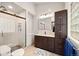 Bathroom featuring a tiled shower, modern vanity, and ample storage space at 24140 Us Highway 40, Golden, CO 80401