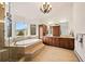 Luxurious bathroom with a soaking tub, glass shower, and wood cabinets at 24140 Us Highway 40, Golden, CO 80401