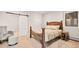 Bright bedroom with a rustic wood bed frame, sliding barn door, and a soft chair at 24140 Us Highway 40, Golden, CO 80401