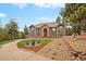 Beautiful exterior elevation showcasing the home's architectural details and landscaped front yard at 24140 Us Highway 40, Golden, CO 80401