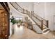 Grand foyer with a curved staircase, stone fireplace, and large windows offering scenic views at 24140 Us Highway 40, Golden, CO 80401