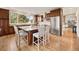 Spacious kitchen features an island with seating, stainless steel appliances, and hardwood floors at 24140 Us Highway 40, Golden, CO 80401