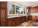 Bright kitchen boasts custom cabinetry, granite countertops, and a large window with scenic views at 24140 Us Highway 40, Golden, CO 80401