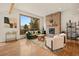 Bright living room featuring a stone fireplace, elegant furniture, and large windows with scenic views at 24140 Us Highway 40, Golden, CO 80401
