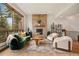 Cozy living room features a stone fireplace, modern furniture, and scenic views through large windows at 24140 Us Highway 40, Golden, CO 80401