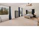 Spacious primary bedroom featuring large windows and a ceiling fan at 24140 Us Highway 40, Golden, CO 80401