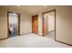 Basement hallway with doors to bathroom and other rooms at 18981 E Belleview Pl, Centennial, CO 80015