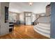 Bright and spacious entryway with hardwood floors, staircase, and views to the dining room at 18981 E Belleview Pl, Centennial, CO 80015