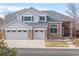 A charming two-story home with a brick facade and a two-car garage located in a quiet neighborhood at 18981 E Belleview Pl, Centennial, CO 80015