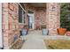 Brick front porch with potted plants and a bench at 18981 E Belleview Pl, Centennial, CO 80015