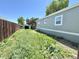 Exterior view of the home's backyard showcasing the side of the residence and yard at 8480 Adams Way, Denver, CO 80229