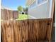 A fenced backyard with mature grass and greenery, offering privacy and space at 8480 Adams Way, Denver, CO 80229