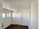 Bright bedroom with two windows, white trim, and a closet door at 8480 Adams Way, Denver, CO 80229