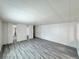 Spacious living area with gray wood flooring and white walls at 8480 Adams Way, Denver, CO 80229