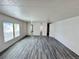 Open-concept living room with stylish gray wood floors and plenty of natural light at 8480 Adams Way, Denver, CO 80229