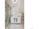 Bathroom with a tub, white patterned vanity, and geometric tile flooring at 2636 W 27Th Ave, Denver, CO 80211