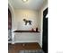 Entryway with a wooden shelf, dog decor, and a black door, offering a welcoming feel with hardwood flooring at 2636 W 27Th Ave, Denver, CO 80211