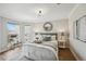 Bright main bedroom with bay windows, ample natural light, and a comfortable queen bed at 2636 W 27Th Ave, Denver, CO 80211