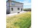 The backyard features a concrete patio, green grass and mountain views at 13315 Xanthia St, Thornton, CO 80602