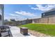 The backyard offers a cozy fire pit, well-maintained lawn, and a wood fence at 13315 Xanthia St, Thornton, CO 80602