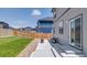 The backyard features a cozy patio, lush grass, and a wooden fence for privacy at 13315 Xanthia St, Thornton, CO 80602