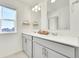 Stylish bathroom featuring double sinks with a window and contemporary fixtures and neutral decor at 13315 Xanthia St, Thornton, CO 80602