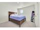 This cozy bedroom is staged with a wooden bed and blue bedding, next to snowboard decor at 13315 Xanthia St, Thornton, CO 80602