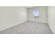 Neutral-toned bedroom with carpet, white walls, and window allowing natural light to fill the room at 13315 Xanthia St, Thornton, CO 80602