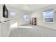 This bright bedroom boasts neutral walls, plush carpeting, and views from the windows overlooking neighborhood at 13315 Xanthia St, Thornton, CO 80602
