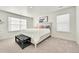 Inviting bedroom featuring a cozy bed with a white comforter and a decorative bench for added comfort at 13315 Xanthia St, Thornton, CO 80602
