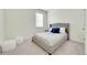 Neutral bedroom featuring a comfortable bed with blue pillows, carpeted floors, and a window at 13315 Xanthia St, Thornton, CO 80602