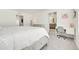 Bright bedroom features a comfortable bed and adjacent desk, with neutral tones throughout at 13315 Xanthia St, Thornton, CO 80602