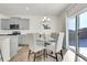 Bright dining area features a modern chandelier, glass table, and sliding doors leading to the outdoors at 13315 Xanthia St, Thornton, CO 80602