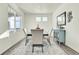 Bright dining room showcasing natural light, modern furnishings, and light hardwood floors at 13315 Xanthia St, Thornton, CO 80602