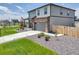 Well-maintained home showcases a spacious driveway, a front porch, and professional landscaping at 13315 Xanthia St, Thornton, CO 80602
