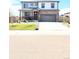Two-story home with a brick-accented facade, covered porch, and well-manicured lawn and front yard at 13315 Xanthia St, Thornton, CO 80602